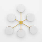 Phosphenes, one of the pieces in the Celeste collection, is entirely handmade. The combination of minimalist shapes, captivating geometries and excellent materials creates the strong personality of this lamp. Thanks to its 6 opaline Murano glass globes supported by 6 brass arms, it stands out in the interior environment it is placed in. Phosphenes can be mounted both as a hanging and a wall lamp.