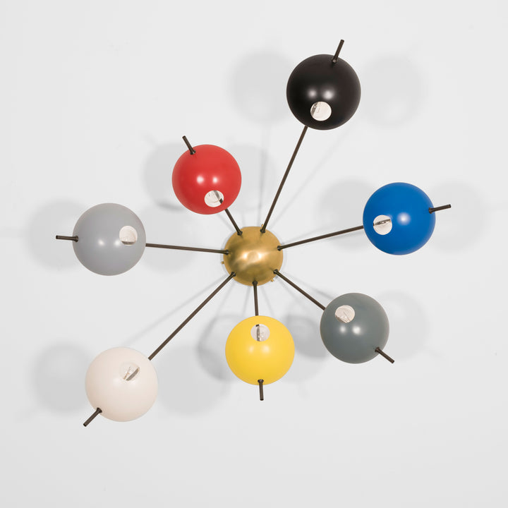 Septem I, with its elements and its shapes simplicity and with its light and shadow effects, represents a tribute to sundials, ancient solar clocks. From a brass core, 7 thin arms branch off, lightly supporting 7 painted brass plates. Septem I becomes a point of light and color in any home interiors, an element of creative and colored decoration.