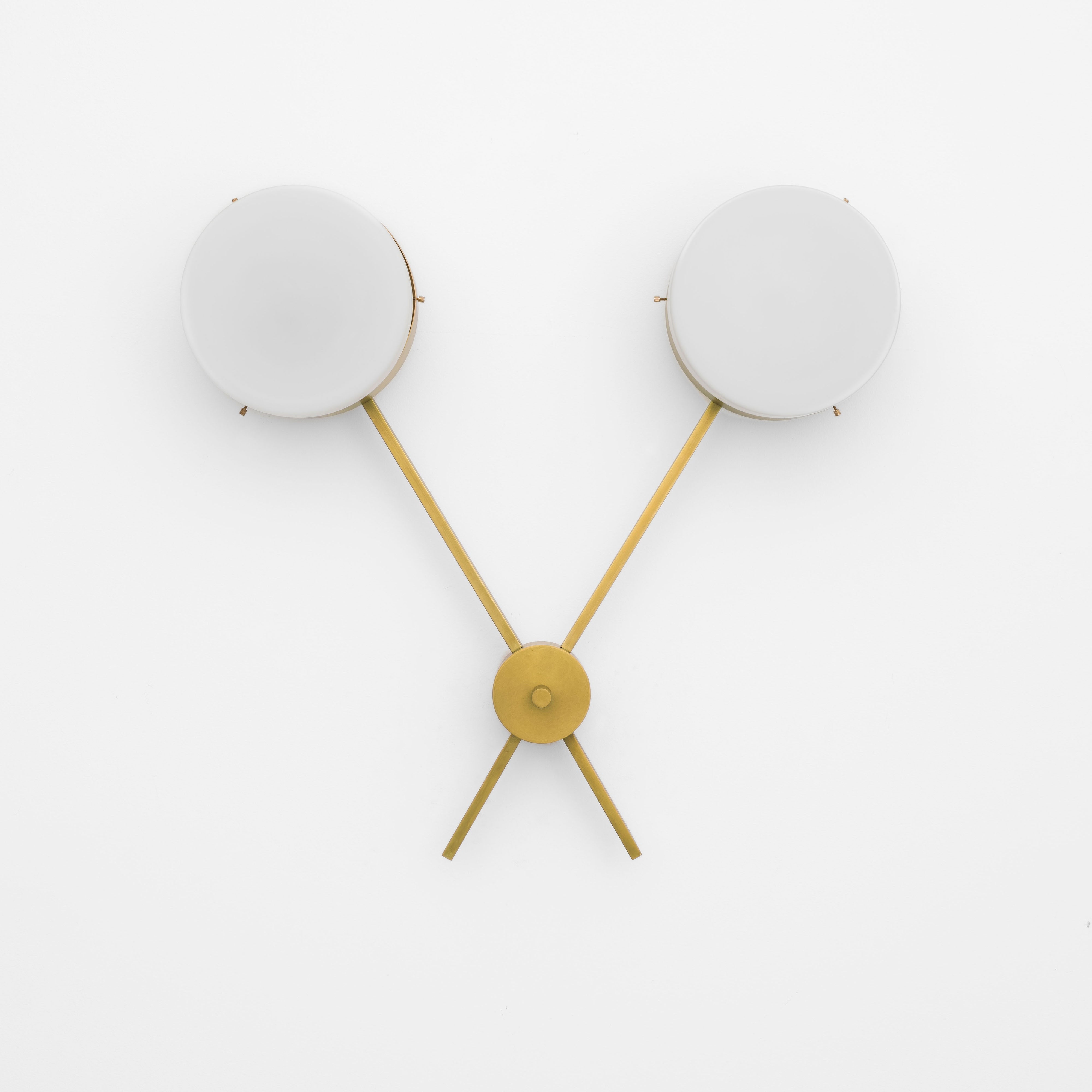 Serendipity, one of the pieces in the Celeste collection, is entirely handmade. The combination of minimalist shapes, captivating geometries and excellent materials creates the strong personality of this lamp. Thanks to its 2 opaline Murano glass globes supported by 2 brass arms, it stands out in the interior environment it is placed in. Serendipity can be mounted both as a hanging and a wall lamp.
