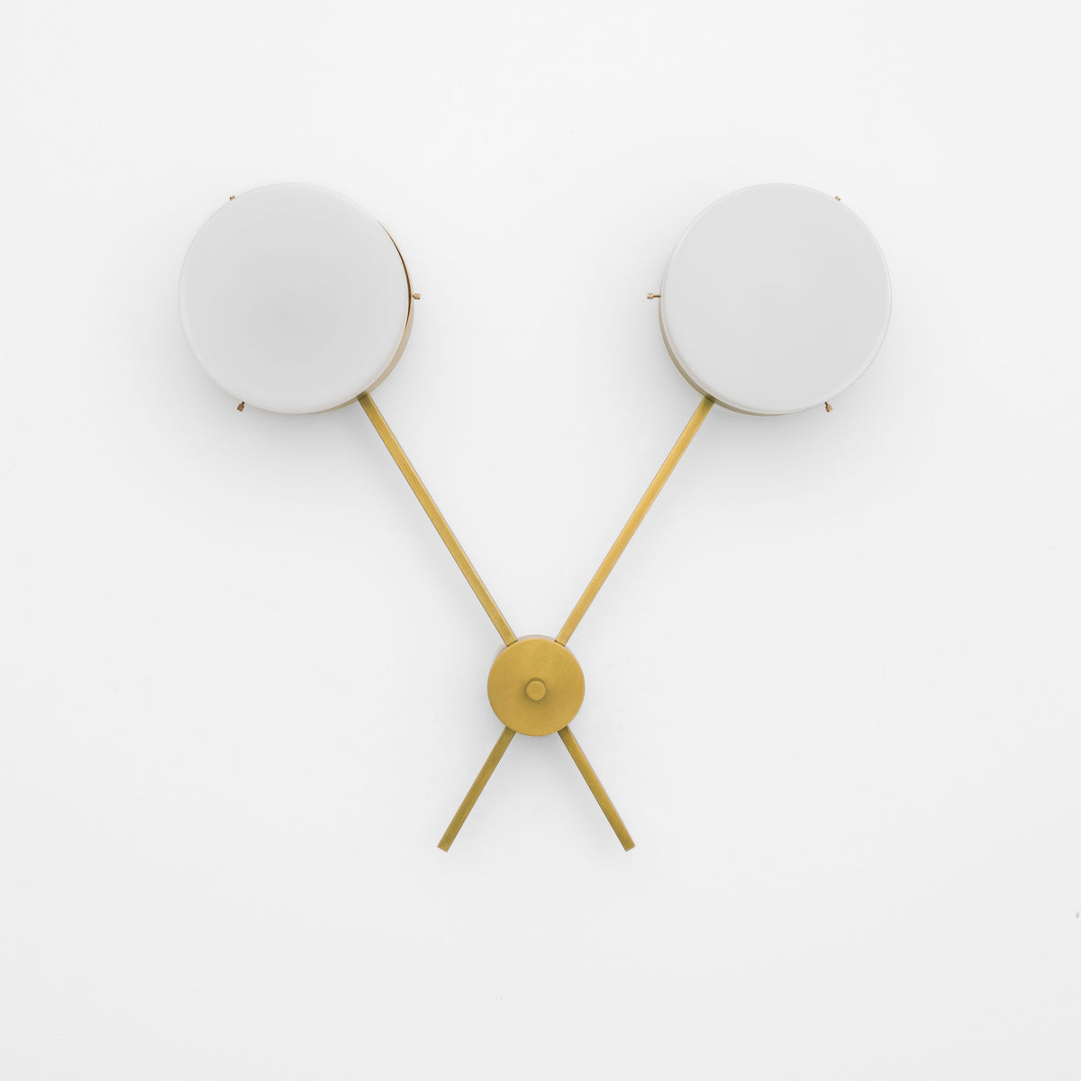 Serendipity, one of the pieces in the Celeste collection, is entirely handmade. The combination of minimalist shapes, captivating geometries and excellent materials creates the strong personality of this lamp. Thanks to its 2 opaline Murano glass globes supported by 2 brass arms, it stands out in the interior environment it is placed in. Serendipity can be mounted both as a hanging and a wall lamp.