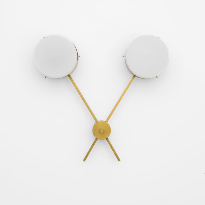 Serendipity, one of the pieces in the Celeste collection, is entirely handmade. The combination of minimalist shapes, captivating geometries and excellent materials creates the strong personality of this lamp. Thanks to its 2 opaline Murano glass globes supported by 2 brass arms, it stands out in the interior environment it is placed in. Serendipity can be mounted both as a hanging and a wall lamp.