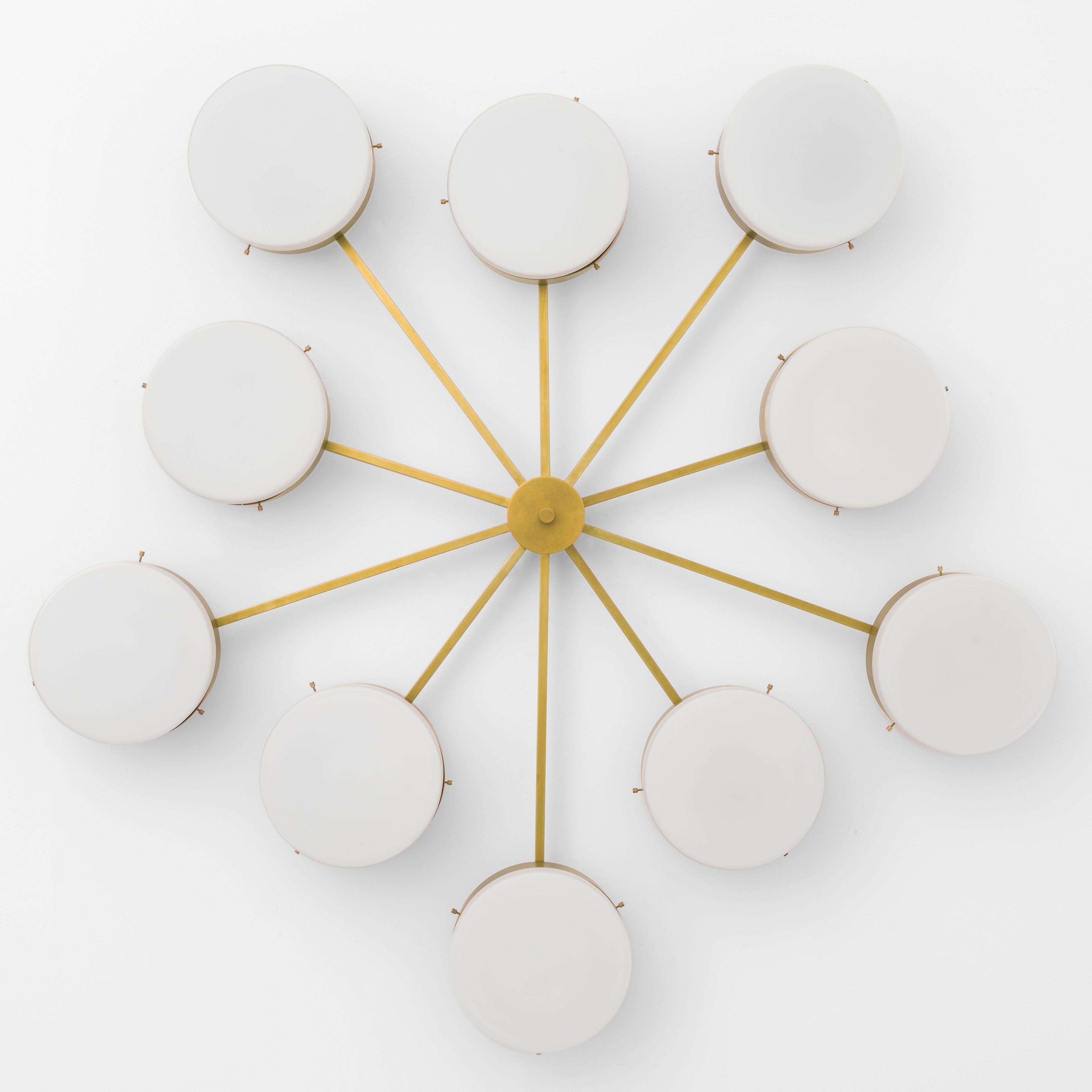 Epoch, one of the pieces in the Celeste collection, is entirely handmade. The combination of minimalist shapes, captivating geometries and excellent materials creates the strong personality of this lamp. Thanks to its 10 opaline Murano glass globes supported by 10 brass arms, it stands out in the interior environment it is placed in. Epoch can be mounted both as a hanging and a wall lamp.