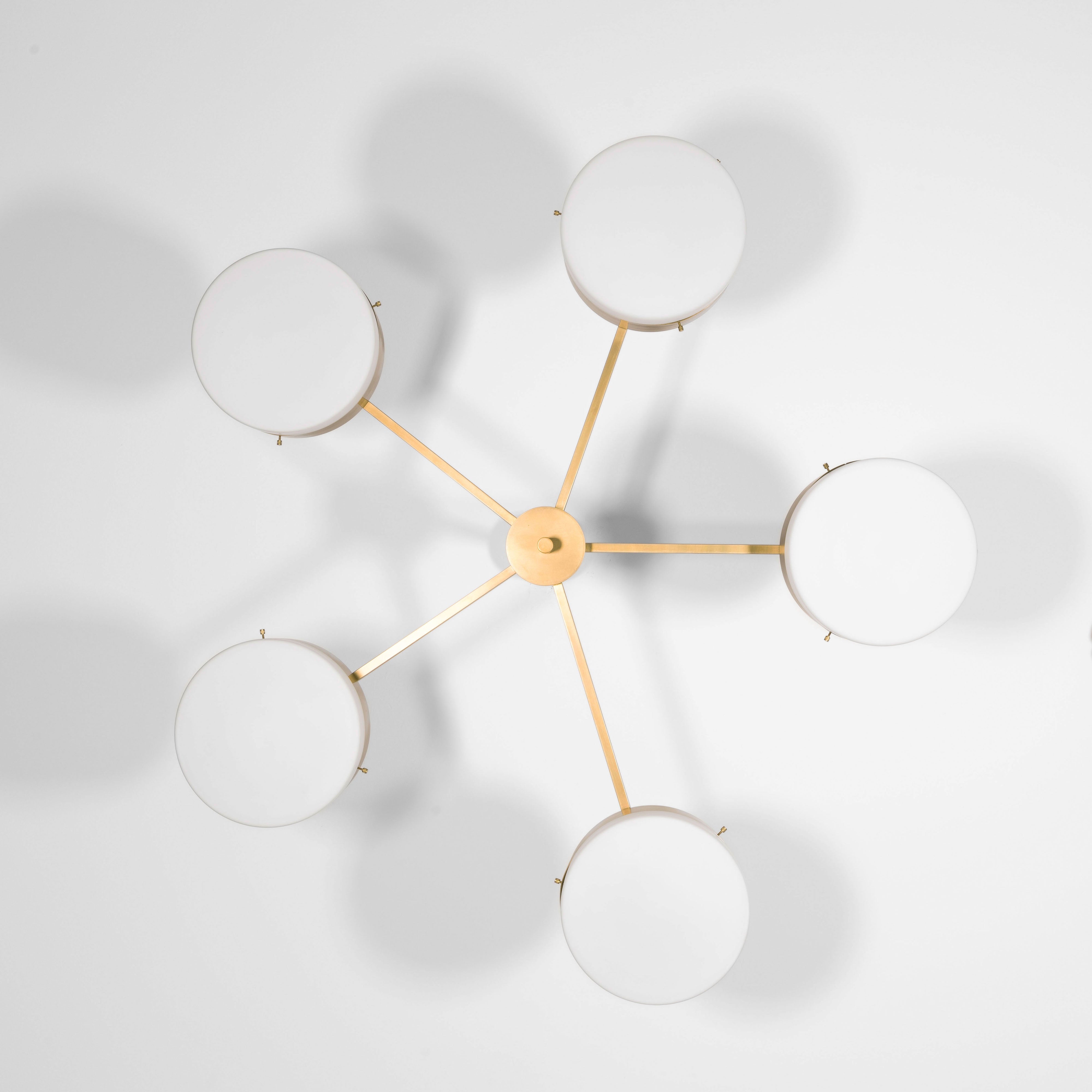 Luminescence, one of the pieces in the Celeste collection, is entirely handmade. The combination of minimalist shapes, captivating geometries and excellent materials creates the strong personality of this lamp. Thanks to its 5 opaline Murano glass globes supported by 5 brass arms, it stands out in the interior environment it is placed in. Luminescence can be mounted both as a hanging and a wall lamp.