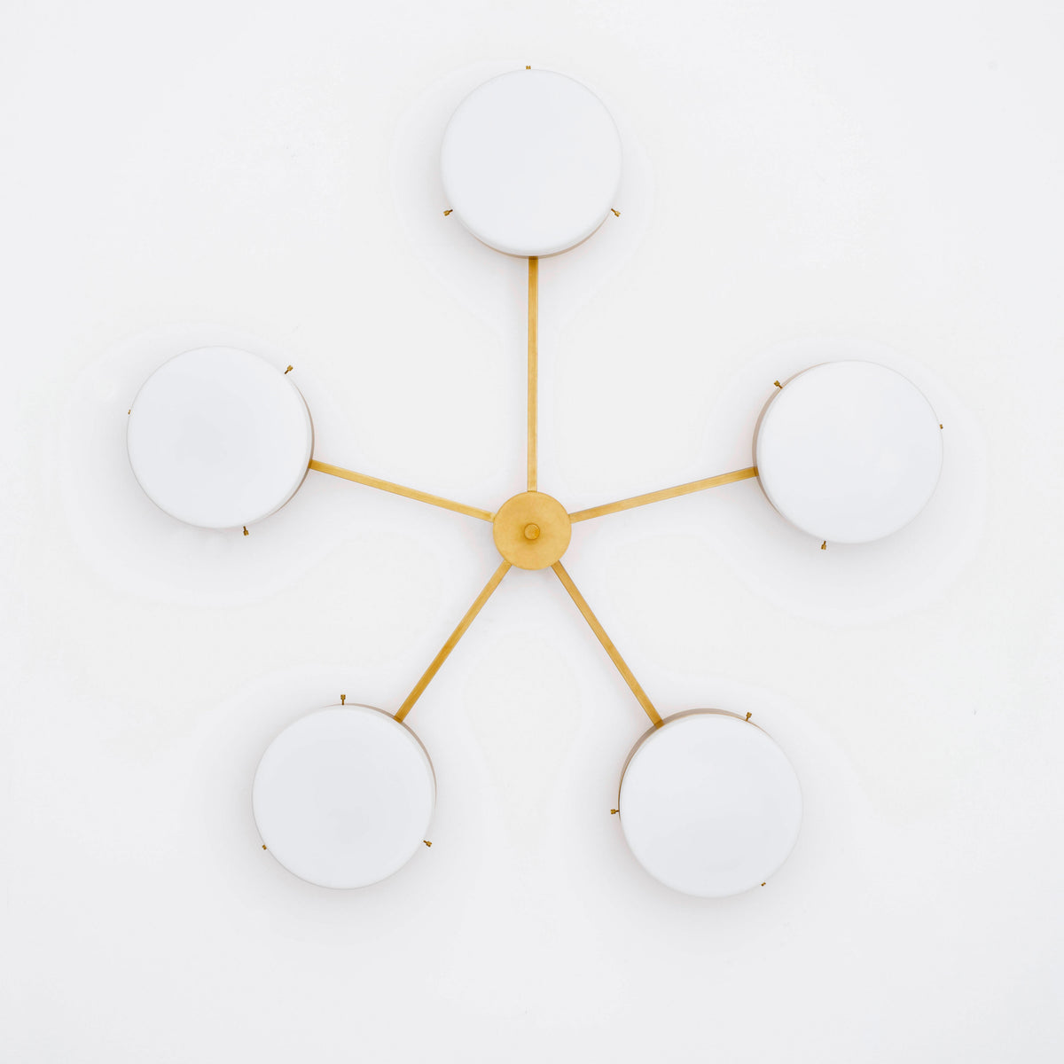 Ethereal, one of the pieces in the Celeste collection, is entirely handmade. The combination of minimalist shapes, captivating geometries and excellent materials creates the strong personality of this lamp. Thanks to its 5 opaline Murano glass globes supported by 5 brass arms, it stands out in the interior environment it is placed in. Ethereal can be mounted both as a hanging and a wall lamp.