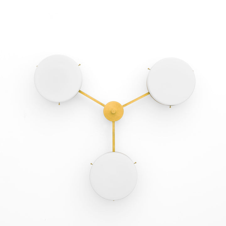 Epiphany, one of the pieces in the Celeste collection, is entirely handmade. The combination of minimalist shapes, captivating geometries and excellent materials creates the strong personality of this lamp. Thanks to its 3 opaline Murano glass globes supported by 3 brass arms, it stands out in the interior environment it is placed in. Epiphany can be mounted both as a hanging and a wall lamp.