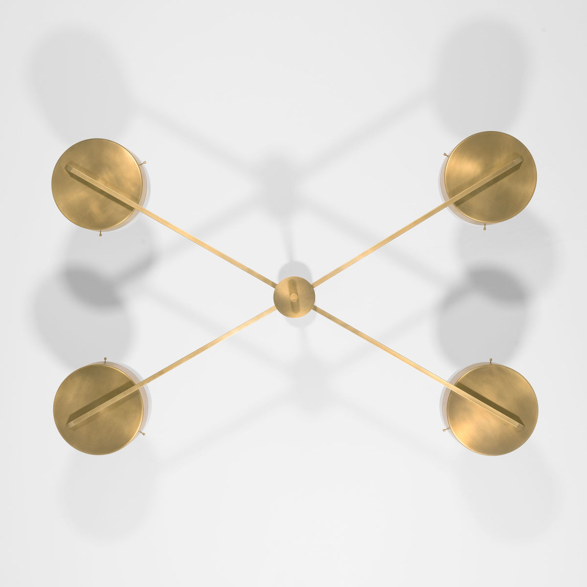 Supine, one of the pieces in the Celeste collection, is entirely handmade. The combination of minimalist shapes, captivating geometries and excellent materials creates the strong personality of this lamp. Thanks to its 4 opaline Murano glass globes supported by 4 brass arms, it stands out in the interior environment it is placed in. Supine can be mounted both as a hanging and a wall lamp.